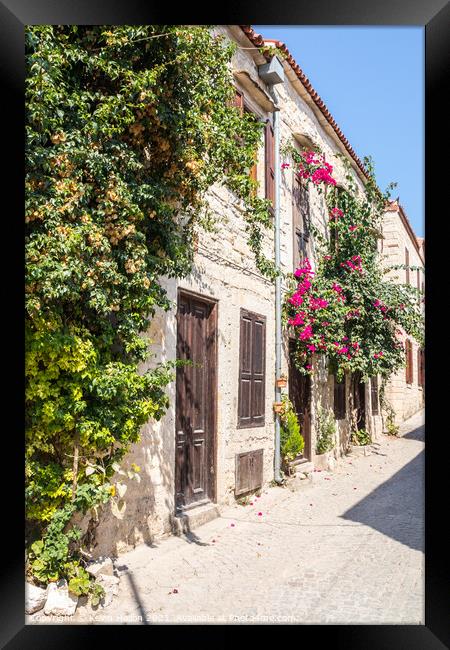 Stone houses covered with bougainvillaea, Framed Print by Kevin Hellon