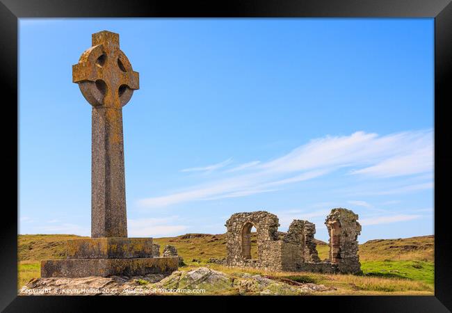 Celtic cross and the remains of St. Dwynwen church Framed Print by Kevin Hellon