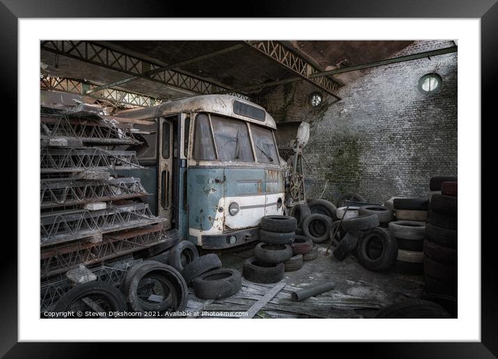 An old blue bus with tires surrounded Framed Mounted Print by Steven Dijkshoorn