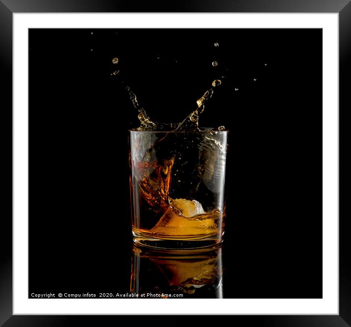 Splash in glass of whiskey and ice Framed Mounted Print by Chris Willemsen