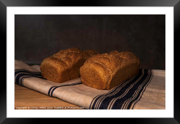 freshly baked bread on wood Framed Mounted Print by Chris Willemsen