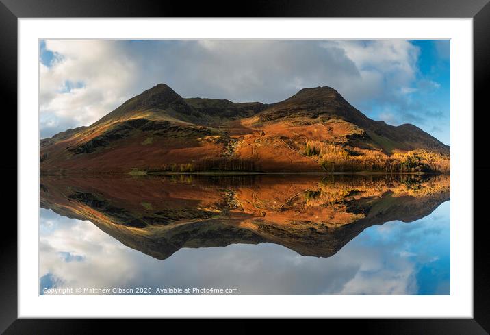 Majestic vibrant Autumn Fall landscape Buttermere in Lake District with beautiful early morning sunlight playing across the hills and mountains Framed Mounted Print by Matthew Gibson