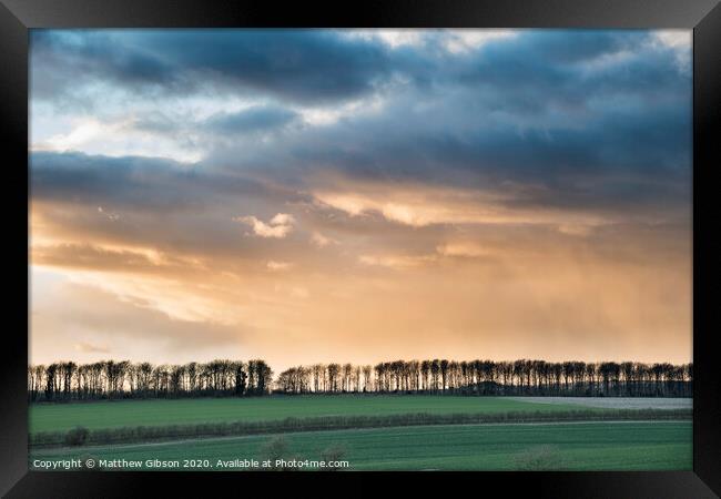 Beautiful stormy moody cloudy sky over English countryside landscape at dusk Framed Print by Matthew Gibson