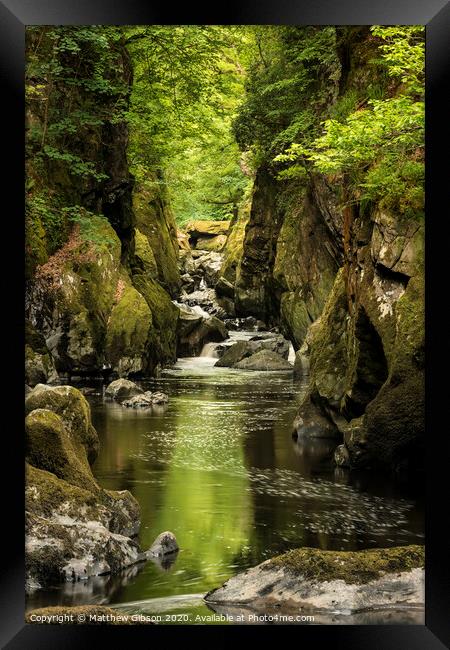 Stunning ethereal landscape of deep sided gorge with rock walls and stream flowing through lush greenery Framed Print by Matthew Gibson