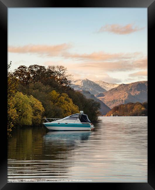 Landscape image of boat moored on Ullswater in Lake District with snowcapped mountains in background with beautiful vibrant Autumn Fall colors Framed Print by Matthew Gibson