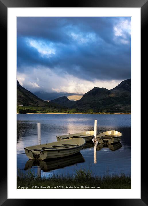 Stunning dramatic stormy sky formations over breathtaking mountain lake landscape with rowing boats in foreground Framed Mounted Print by Matthew Gibson