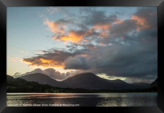 Beautiful sunrise landscape image looking across Loweswater in the Lake District towards Low Fell and Grasmere with vibrant sunrise sky breaking on the mountain peaks Framed Print by Matthew Gibson