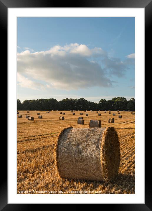 Beautiful countryside landscape image of hay bales in Summer field during colorful sunset Framed Mounted Print by Matthew Gibson