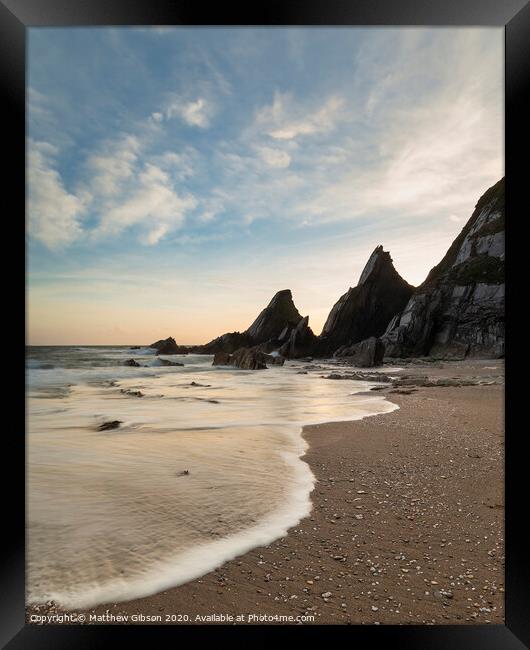 Stunning sunset landscape image of Westcombe Beach in Devon England with jagged rocks on beach and stunning cloud formations Framed Print by Matthew Gibson