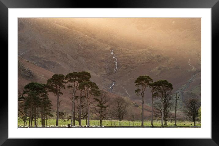 Majestic vibrant Autumn Fall landscape Buttermere in Lake District with beautiful early morning sunlight playing across the hills and mountains Framed Mounted Print by Matthew Gibson