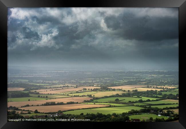 Stunning Summer landscape image of escarpment with dramatic storm clouds and sun beams streaming down Framed Print by Matthew Gibson