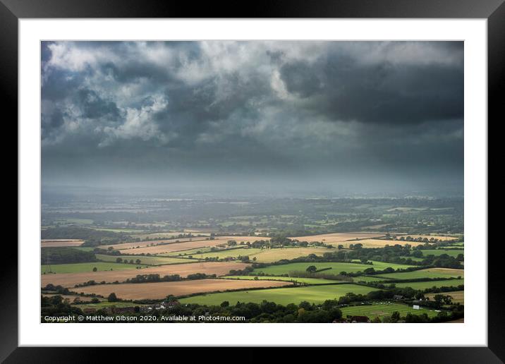 Stunning Summer landscape image of escarpment with dramatic storm clouds and sun beams streaming down Framed Mounted Print by Matthew Gibson
