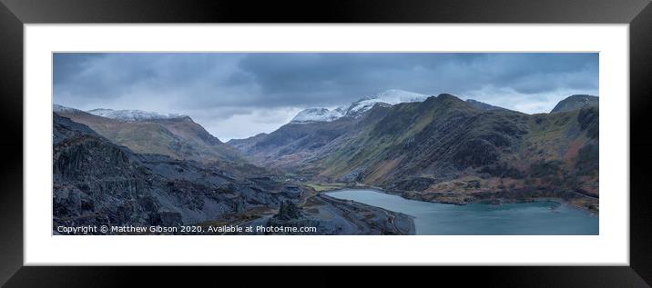 Beautiful landscape image of Dinorwig Slate Mine and snowcapped Snowdon mountain in background during Winter in Snowdonia with Llyn Peris in foreground Framed Mounted Print by Matthew Gibson