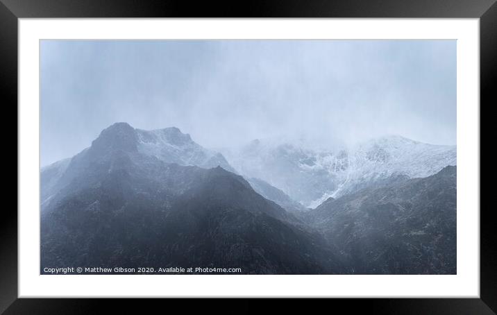 Stunning moody dramatic Winter landscape image of snowcapped Y Garn mountain in Snowdonia Framed Mounted Print by Matthew Gibson