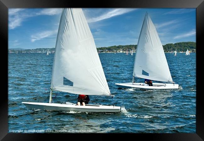 Teens racing in small sailboat with white sails. Framed Print by Geoff Childs