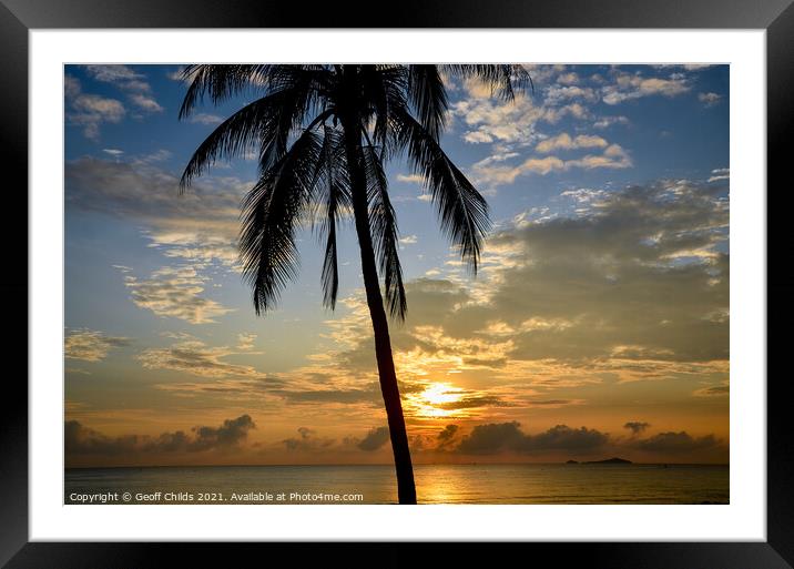 Tropical sunrise seascape with a palm tree silhouette in a blue  Framed Mounted Print by Geoff Childs