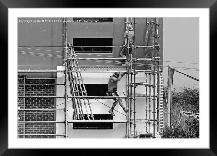 Construction workers dismantling scaffolding on new construction Framed Mounted Print by Geoff Childs