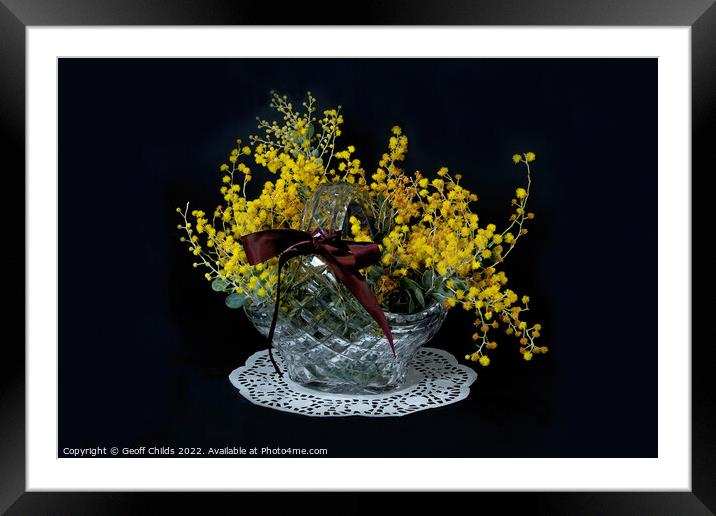 Wattle blossoms in a crystal glass basket vase on black. Wattle  Framed Mounted Print by Geoff Childs
