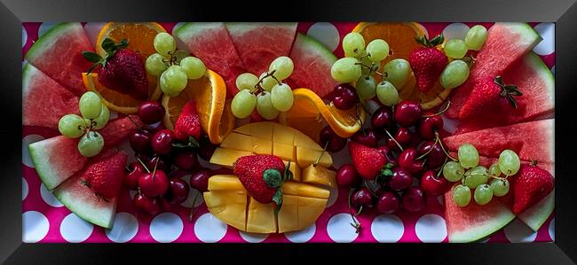 A colourful Christmas breakfast fruit platter on a dining table closeup. Framed Print by Geoff Childs