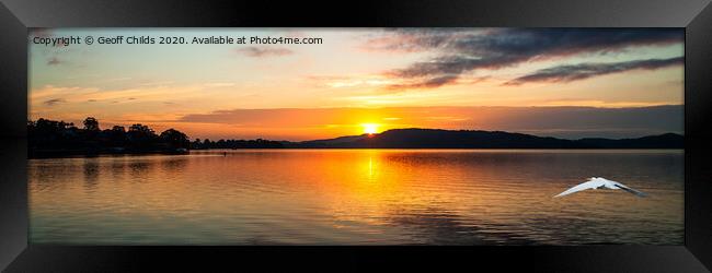 Orange sunrise waterscape reflections panorama. Framed Print by Geoff Childs