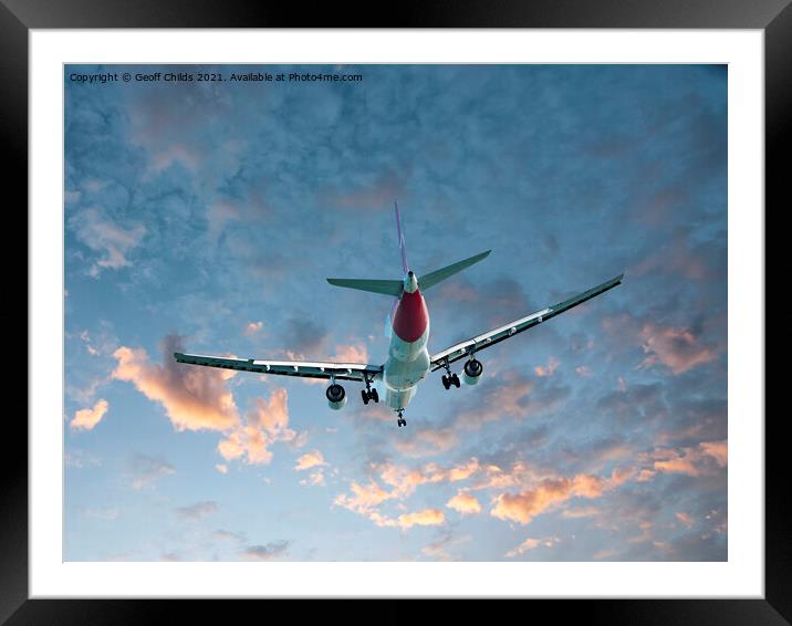 Aircraft flying into orange sunrise cloud. Framed Mounted Print by Geoff Childs