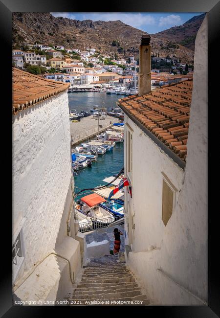 Rooftops and marina of Hydra. Framed Print by Chris North