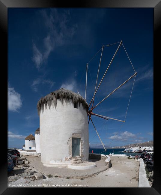 Windmills overlooking Mykonos town. Framed Print by Chris North