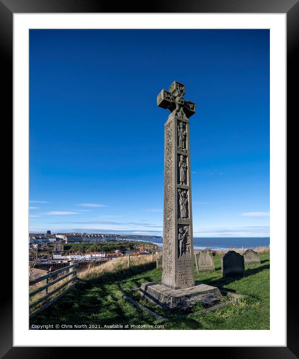 Celtic cross overlooking the seaside town of Whitby. Framed Mounted Print by Chris North