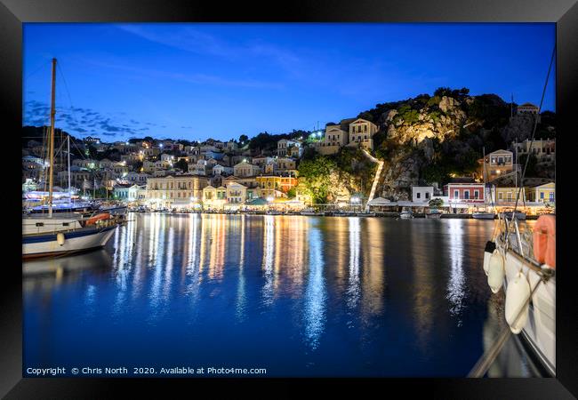Symi Harbour at night Framed Print by Chris North