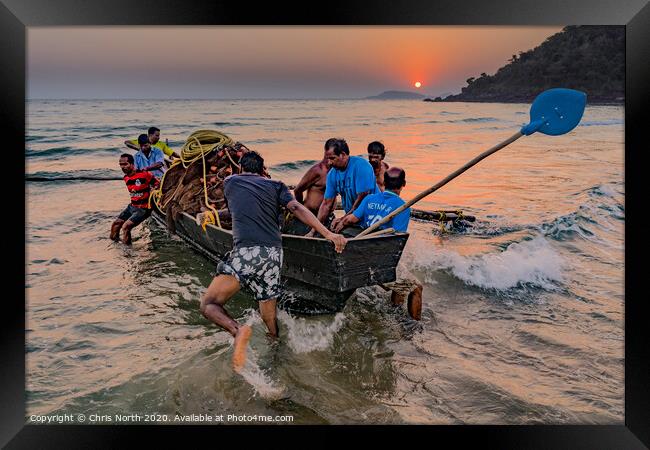 Goa, fisherman launching boat at sunset. Framed Print by Chris North
