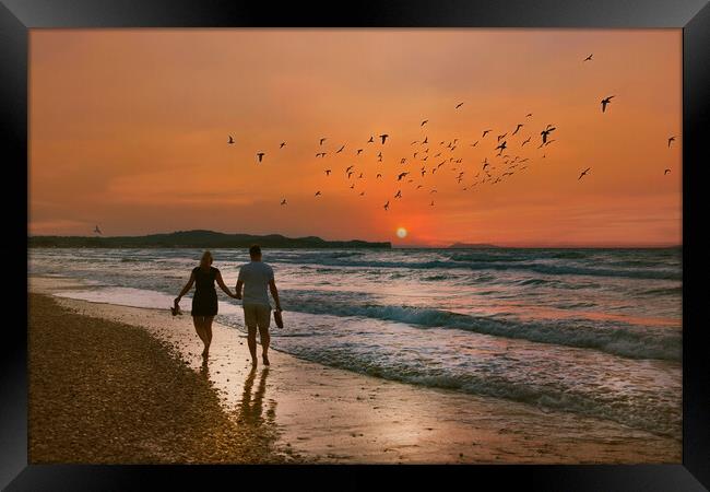 Lovers Stroll along the Beach at Sunset Framed Print by Dave Williams