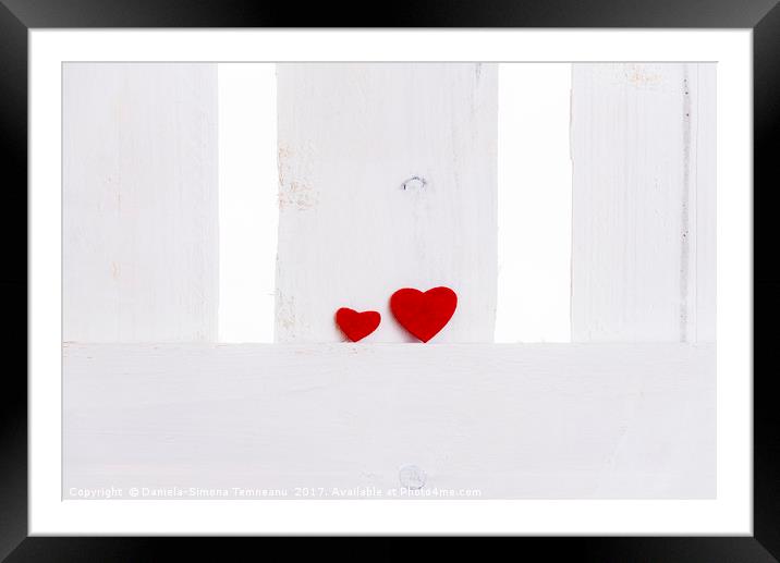 Big and small red hearts on a fence Framed Mounted Print by Daniela Simona Temneanu