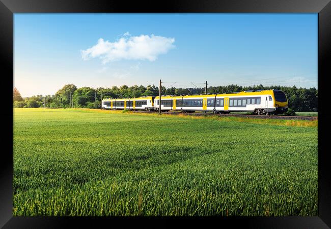 German passenger train in motion. Yellow electric train traveling Framed Print by Daniela Simona Temneanu