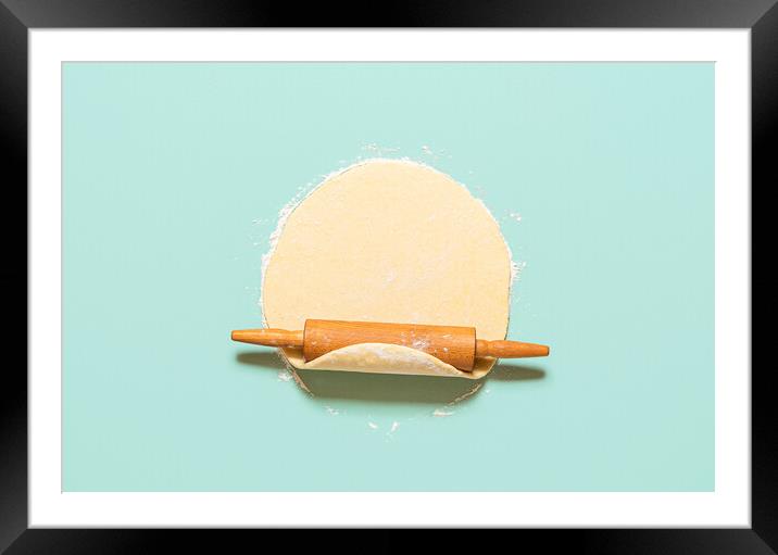 Dough rolled out on a green background. Homemade pie crust and rolling pin. Baking concept Framed Mounted Print by Daniela Simona Temneanu