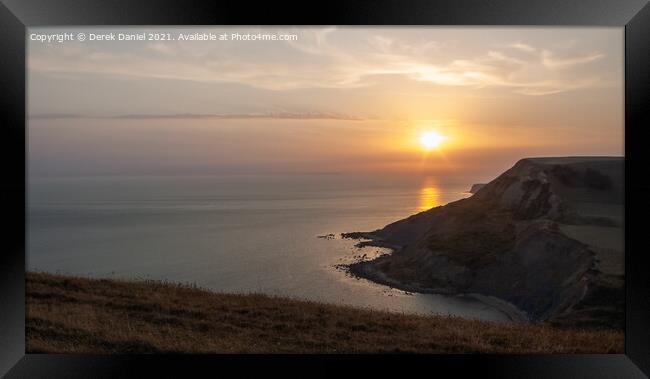 Jurassic coastline nearing Sunset Framed Print by Derek Daniel