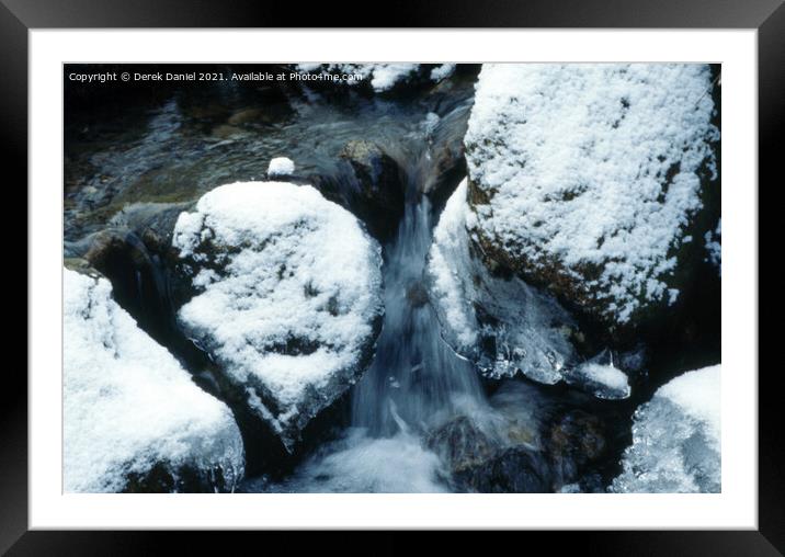 snow covered rocks Framed Mounted Print by Derek Daniel