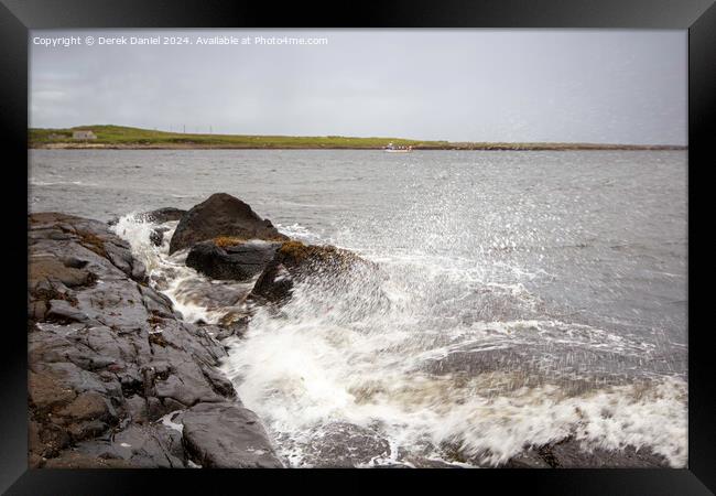 Waves crashing into the rocks at Staffin Bay Framed Print by Derek Daniel