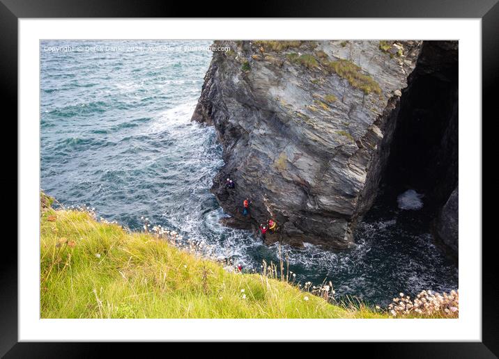 Coasterring around the cliffs at Port Gaverne Framed Mounted Print by Derek Daniel