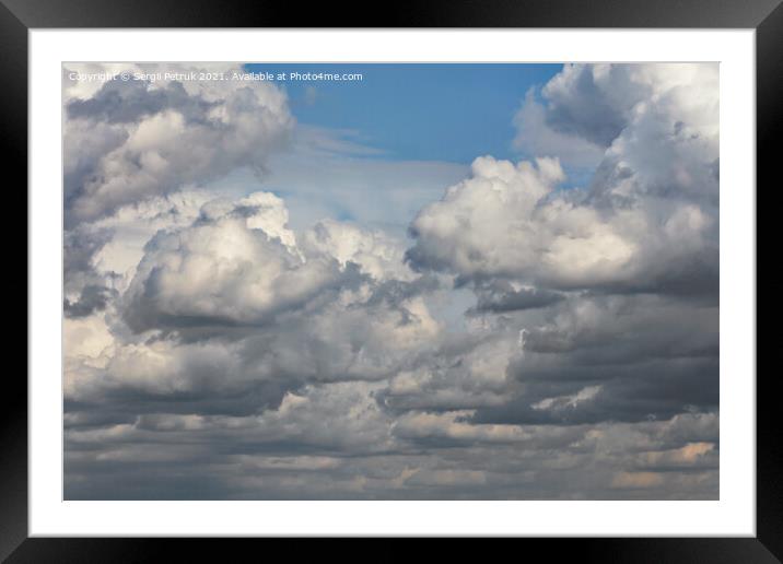 Cumulus clouds are gradually covering the blue sky. Framed Mounted Print by Sergii Petruk