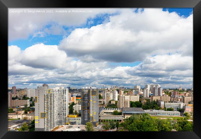 Dramatic beautiful sky with thick clouds over residential areas of the city. Framed Print by Sergii Petruk