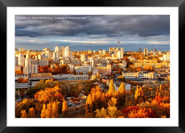 Contrasting golden illumination of the setting sun rays of city buildings and streets. Framed Mounted Print by Sergii Petruk