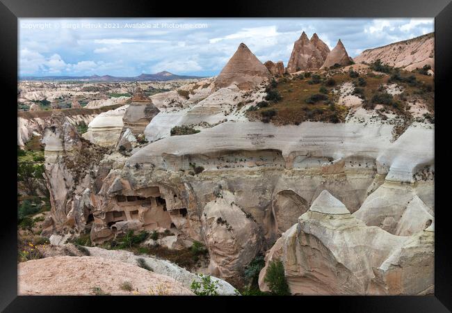 Ancient caves in the rocky mountain ranges of Cappadocia, an unusual landscape of central Turkey. Framed Print by Sergii Petruk