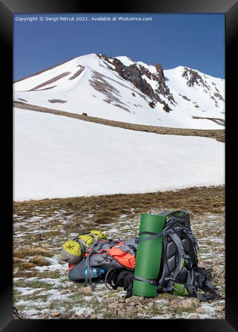 Camping equipment against the background of a snow-capped mountain and blue sky. Framed Print by Sergii Petruk