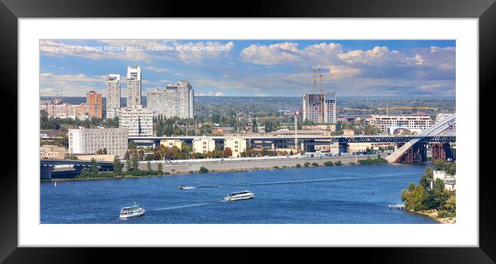 Panoramic cityscape of the Dnipro with cruising pleasure boats against the background of the Kyiv embankment, bright beautiful sky and city buildings. Framed Mounted Print by Sergii Petruk