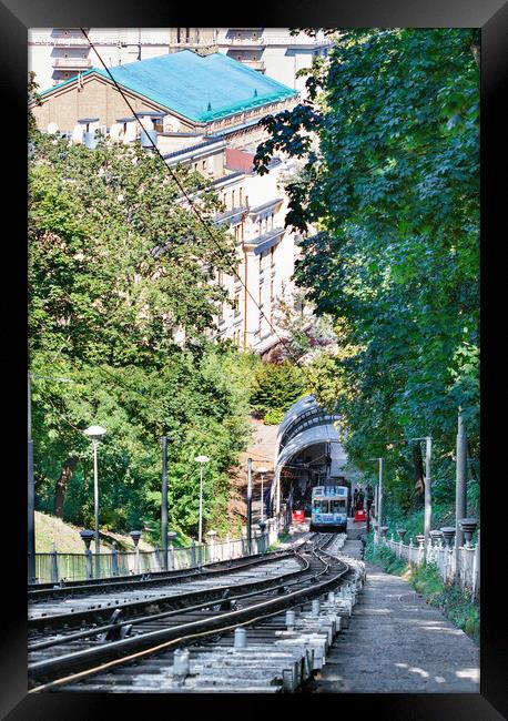Funicular rail track, the car is filled with passengers at the lower station, surrounded by a summer green park. Framed Print by Sergii Petruk