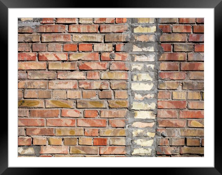 On an old wall of red bricks a separated vertical fragment of the old silicate brick Framed Mounted Print by Sergii Petruk