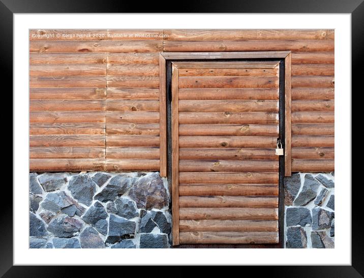 Wooden door to the utility room of a house standing on a stone foundation Framed Mounted Print by Sergii Petruk