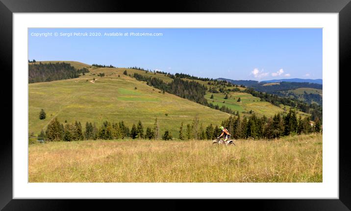 Motorcyclist moves down the slope of the Carpathian Mountains Framed Mounted Print by Sergii Petruk