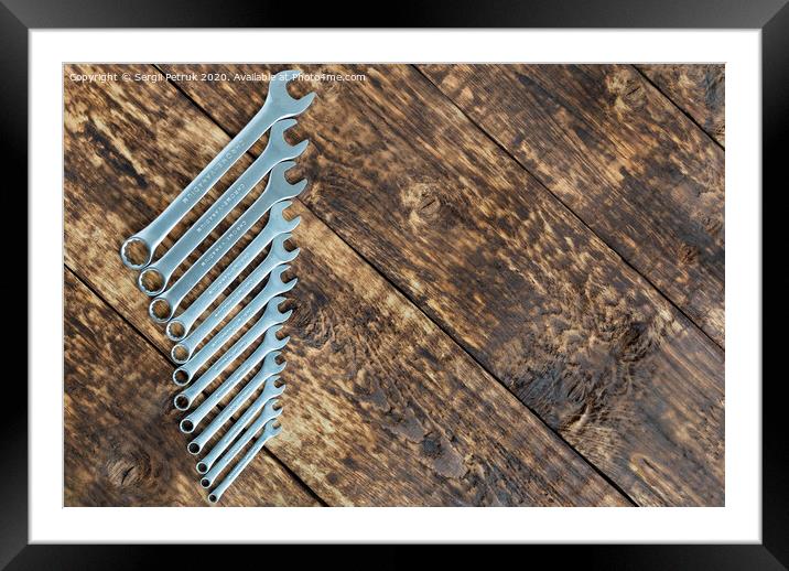 set of wrench against old wooden boards background Framed Mounted Print by Sergii Petruk