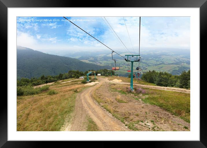 The mountain lift carries tourists and luggage up and down the mountains Framed Mounted Print by Sergii Petruk